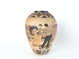 a vase with a picture of a man and a woman on it