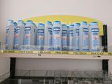 many bottles of water sitting on a shelf in a store