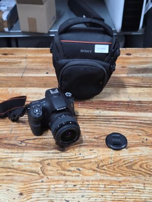 a camera and a bag on a wooden table