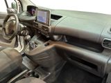 a picture of a car dashboard with a monitor and steering wheel