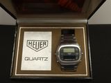 a close up of a watch in a box on a table