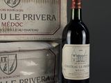 a bottle of red wine next to a box of cheese