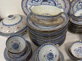 a lot of blue and white plates and bowls on a table