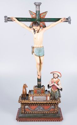 statue of jesus on the cross with three wise men and a dog