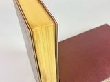 an open book sitting on top of a table next to a closed book