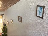 an image of a living room with white walls and wood flooring