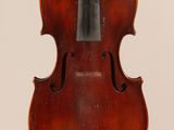 an old violin with a bow hanging from it ' s back