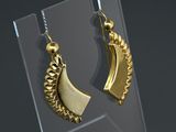 pair of gold plated earrings on display in a glass case