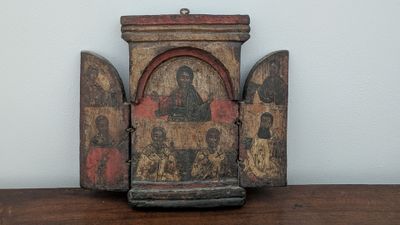 an old wooden box with a painting on it sitting on a table