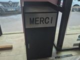 a sign that says merci on it in front of a window