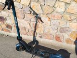 a scooter that is parked on the side of the street