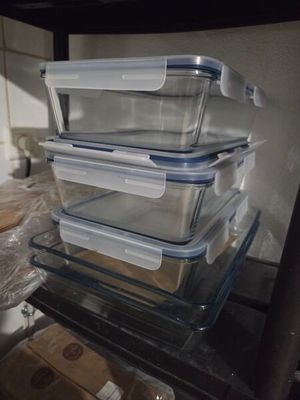 several plastic containers are stacked on top of each other on a shelf