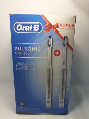two toothbrushes in a box on a white background