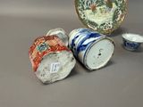 several different types of chinese vases and bowls on a table