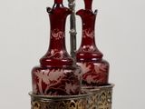 two red vases sitting on top of a wooden table