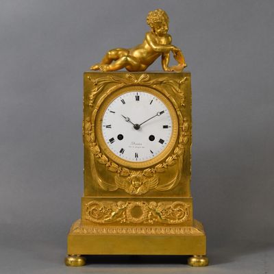 a gold clock with a statue of a lion on top of it