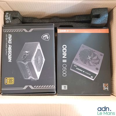 two boxes of computer equipment sitting in a box