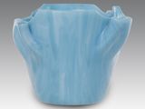 a blue vase that is sitting on a table