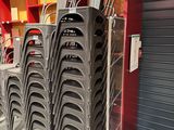 many chairs stacked on top of each other in a store