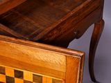 an old wooden table with a chess board on top of it