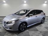 a silver nissan leaf electric car parked on a checkered floor