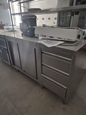 a large kitchen with stainless steel cabinets and a counter top