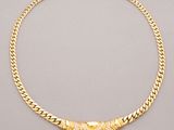 a gold necklace with a diamond clasp on a chain
