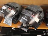 three helmets that are on a shelf in a room