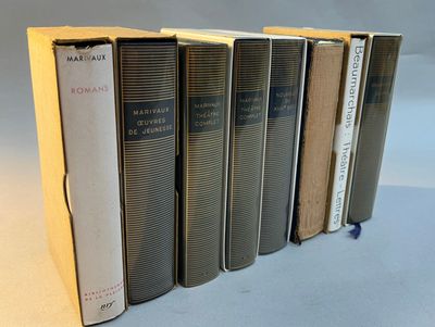 six books are lined up in a row on a table