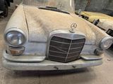 an old car that is sitting in a garage