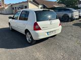 a small white car parked in a parking lot