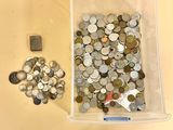 a lot of coins in a container on the table