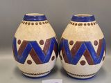 pair of ceramic vases with geometric designs on them on display