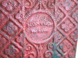 a close up of a red metal object on a table