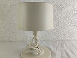 a lamp that is sitting on a table in front of a wall