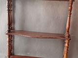 an image of a wooden shelf with three shelves on it