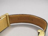 a close up of a watch with a leather band