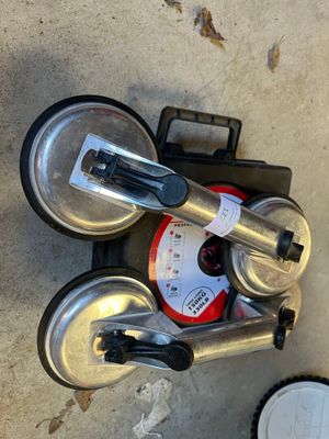 a silver blender sitting on the ground next to a can of soda