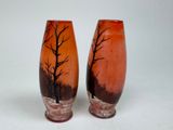 two vases that have been painted with trees on them