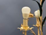 a light that is on a pole with some flowers