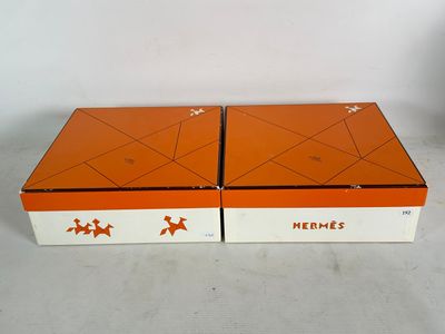 pair of orange and white boxes with stars on them sitting on a table