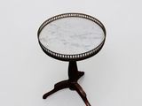 a small table with a marble top sitting on a wooden stand