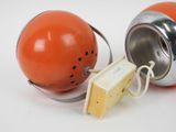 two orange and silver objects on a white surface