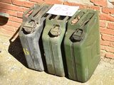 four suitcases sitting next to each other on the ground