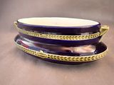 a purple and gold plate with a spoon on top of it