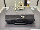 a black case with a yellow cord on top of it