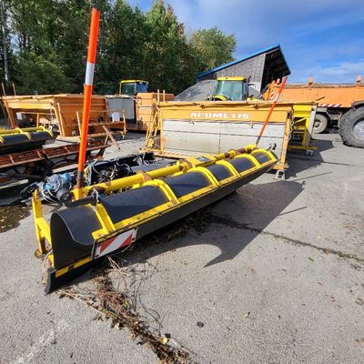 an image of a yellow snow plow parked in a parking lot