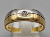 a yellow and white gold wedding ring with a diamond