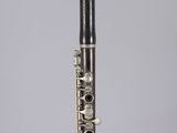 a close up of a flute in a clear box on a white surface