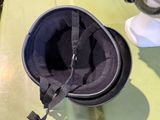 a helmet that is sitting on a table next to a fan